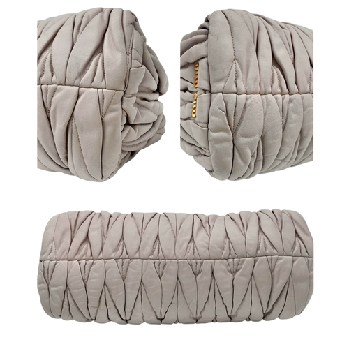 348 - A Miu Miu Matelassé Leather Shoulder Bag. Light purple leather exterior with gold-toned hardware, du... 