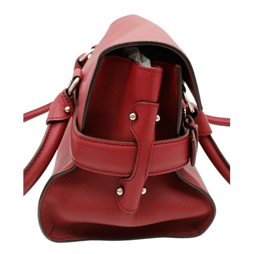 355 - A Salvatore Ferragamo Red Leather Handbag. Red leather exterior with silver-toned hardware, dual top... 