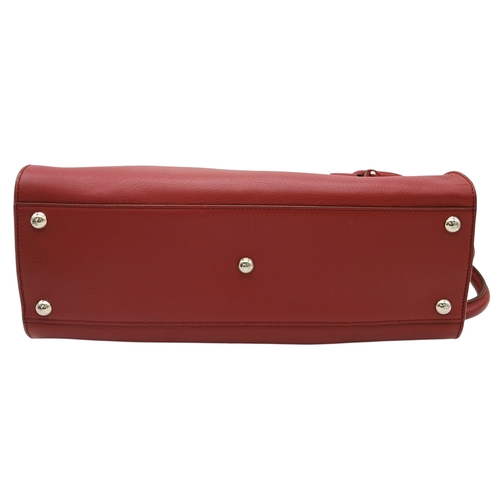355 - A Salvatore Ferragamo Red Leather Handbag. Red leather exterior with silver-toned hardware, dual top... 