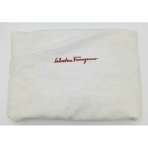 355 - A Salvatore Ferragamo Red Leather Handbag. Red leather exterior with silver-toned hardware, dual top... 