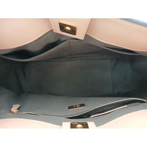 37 - A Fendi Pink Coated Tote Bag. Pink leather exterior with gold-toned hardware, dual top handles, a sn... 