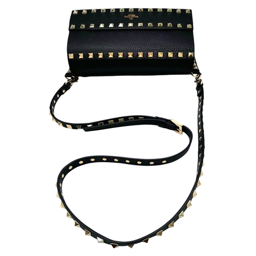 44 - A Valentino Garavani Black Rockstud Crossbody Bag. Black leather exterior with gold-tone hardware, d... 