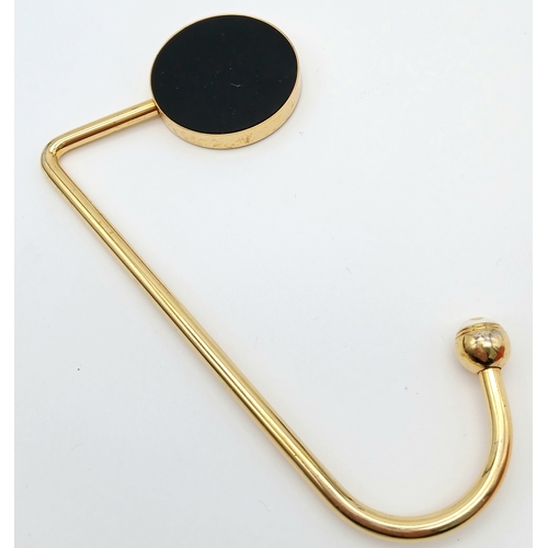 299 - A Louis Vuitton Red and Gold-Toned Monogram Flower Bag Holder. Gold-toned hardware with a red circul... 