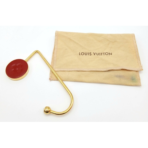 299 - A Louis Vuitton Red and Gold-Toned Monogram Flower Bag Holder. Gold-toned hardware with a red circul... 