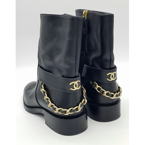 300 - A pair of Chanel Calfskin Chain High Boots. Size 38 1/2. Black leather exterior with round toes, sma... 