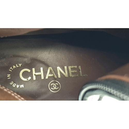 300 - A pair of Chanel Calfskin Chain High Boots. Size 38 1/2. Black leather exterior with round toes, sma... 