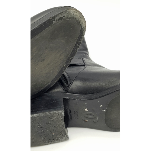 300 - A pair of Chanel Calfskin Chain High Boots. Size 38 1/2. Black leather exterior with round toes, sma... 