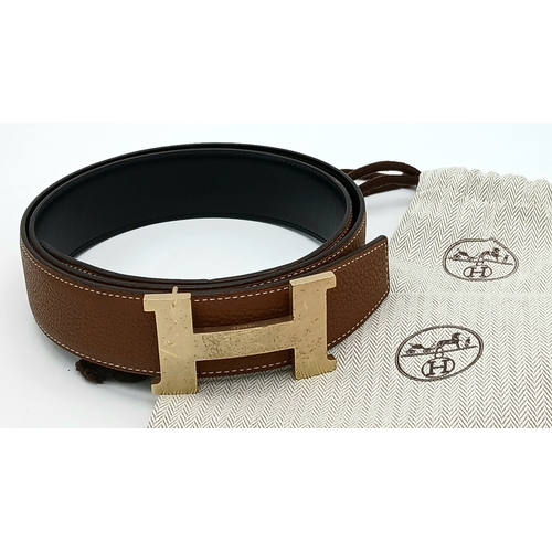 320 - A Hermès Reversible Leather Belt. Tan grained leather on one side, smooth black leather on the other... 