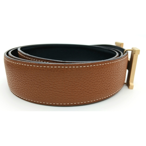 320 - A Hermès Reversible Leather Belt. Tan grained leather on one side, smooth black leather on the other... 