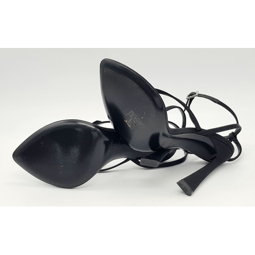 219 - A pair of Saint Laurent strappy heeled sandals. Black satin exterior with leather insoles, featuring... 