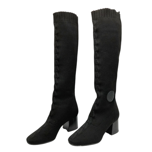 226 - A pair of Hermes knit calfskin Fontaine 60 Boots. size 35. Black knit exterior with leather accents ... 