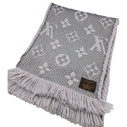 232 - A Louis Vuitton Wool Silk Logomania scarf in Pearl Grey with fringed edge. Size approx: 152.5cm x 31... 