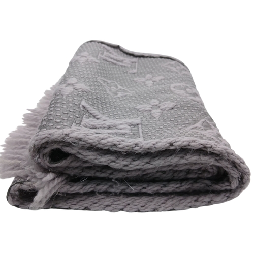 232 - A Louis Vuitton Wool Silk Logomania scarf in Pearl Grey with fringed edge. Size approx: 152.5cm x 31... 