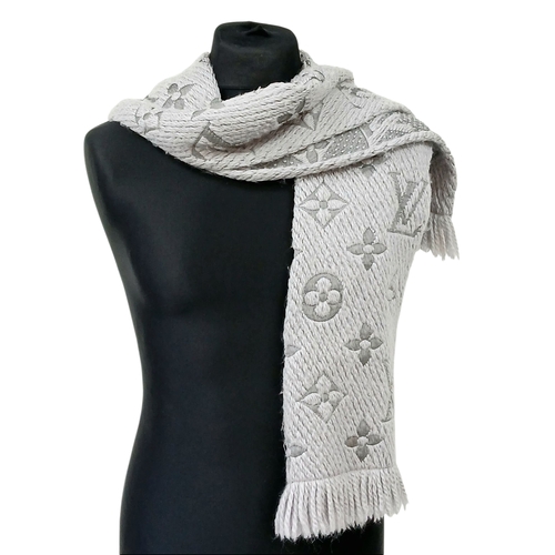 232 - A Louis Vuitton Wool Silk Logomania scarf in Pearl Grey with fringed edge. Size approx: 152.5cm x 31... 