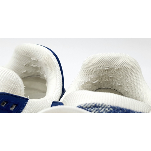 256 - A pair of Louis Vuitton embossed monogram denim sneakers. White leather and monogram denim exterior.... 