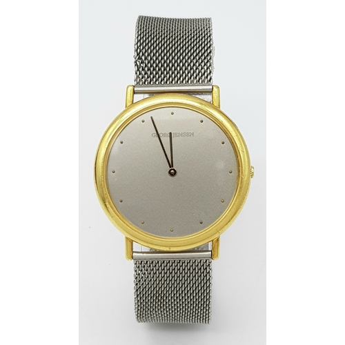 31 - A Georg Jensen 18K Gold Watch. Mesh bracelet. 18k gold case - 35mm. Silver tone dial. Quartz movemen... 