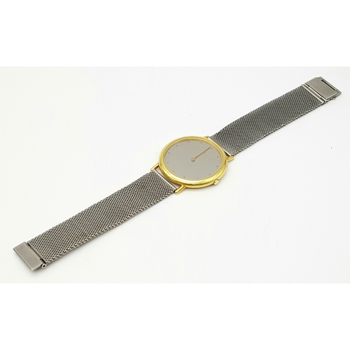 31 - A Georg Jensen 18K Gold Watch. Mesh bracelet. 18k gold case - 35mm. Silver tone dial. Quartz movemen... 