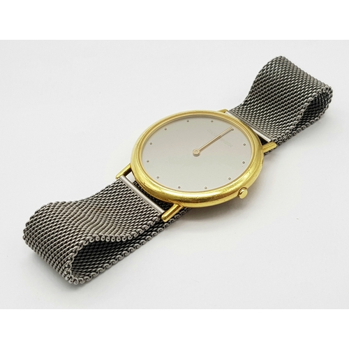 31 - A Georg Jensen 18K Gold Watch. Mesh bracelet. 18k gold case - 35mm. Silver tone dial. Quartz movemen... 
