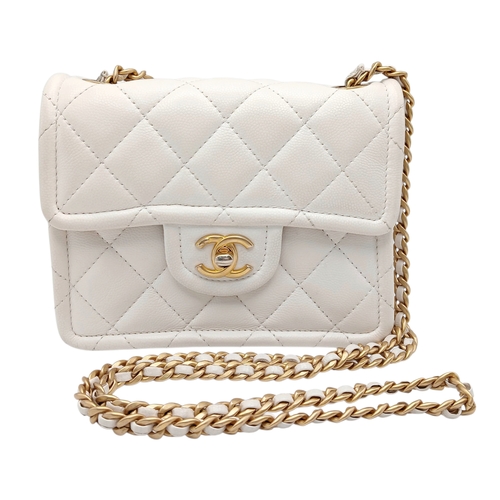 A Chanel Caviar Quilted Classic Flap Bag. White diamond-quilted caviar leather with gold-toned hardware, featuring a leather-threaded chain shoulder strap and the iconic Chanel CC turn-lock closure. The top flap opens to a white leather interior with a zipped inner side pocket. Comes with a dust cover bag. Approximate size: 17.7cm length x 13.5cm height. Show stains to the interior, good condition to the exterior - Please see photos or request a condition report.  Ref: J207