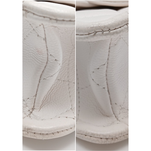 505 - A Chanel Caviar Quilted Classic Flap Bag. White diamond-quilted caviar leather with gold-toned hardw... 