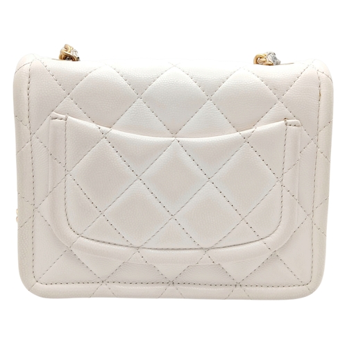 505 - A Chanel Caviar Quilted Classic Flap Bag. White diamond-quilted caviar leather with gold-toned hardw... 