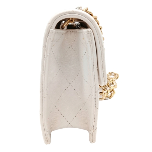 505 - A Chanel Caviar Quilted Classic Flap Bag. White diamond-quilted caviar leather with gold-toned hardw... 
