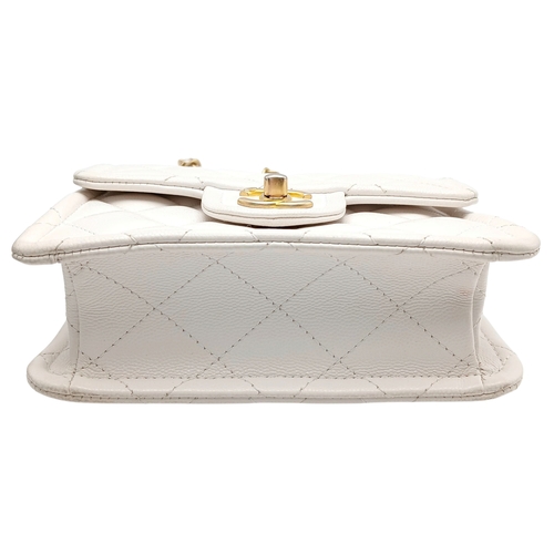 505 - A Chanel Caviar Quilted Classic Flap Bag. White diamond-quilted caviar leather with gold-toned hardw... 