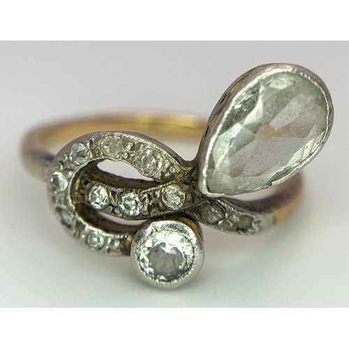 33 - An Antique Edwardian 18K Gold, Platinum and Diamond Ring. Abstract form with Pear and Old Cut Diamon... 