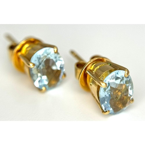 332 - An 18K Yellow Gold, Aquamarine Ring and Earring Set. Ring - 2ct oval cut, size L 1/2. Earrings - 2.5... 