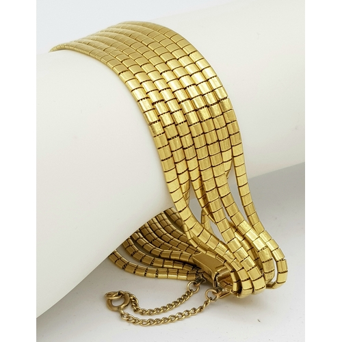 162 - A Beautiful 18K Yellow Gold (tested) Seven Strand Link Bracelet. Clip open design with safety chain.... 