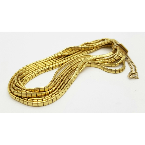 162 - A Beautiful 18K Yellow Gold (tested) Seven Strand Link Bracelet. Clip open design with safety chain.... 