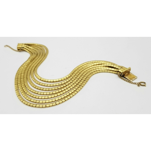 162 - A Beautiful 18K Yellow Gold (tested) Seven Strand Link Bracelet. Clip open design with safety chain.... 