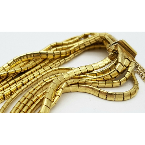 162 - A Beautiful 18K Yellow Gold (tested) Seven Strand Link Bracelet. Clip open design with safety chain.... 