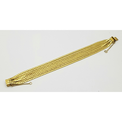 162 - A Beautiful 18K Yellow Gold (tested) Seven Strand Link Bracelet. Clip open design with safety chain.... 
