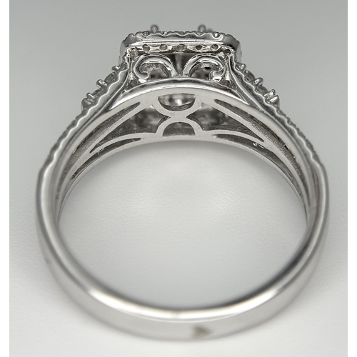 166 - A 14K WHITE GOLD DIAMOND TRIPLE HALO RING WITH DIAMOND SET SHOULDERS. MARKED BELLAGIO INSIDE. 0.90CT... 