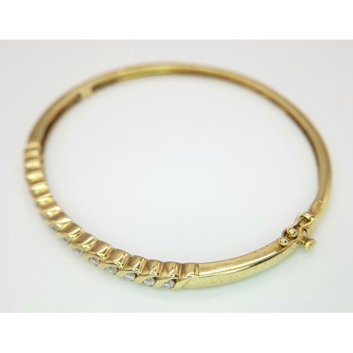 65 - A 9K YELLOW GOLD DIAMOND SET BANGLE 9.1G TOTAL WEIGHT, 0.45CT, 5CM x 6CM. REF: JB 3003