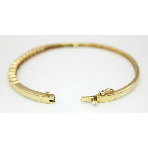 65 - A 9K YELLOW GOLD DIAMOND SET BANGLE 9.1G TOTAL WEIGHT, 0.45CT, 5CM x 6CM. REF: JB 3003
