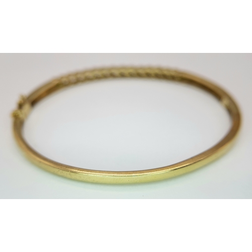 65 - A 9K YELLOW GOLD DIAMOND SET BANGLE 9.1G TOTAL WEIGHT, 0.45CT, 5CM x 6CM. REF: JB 3003