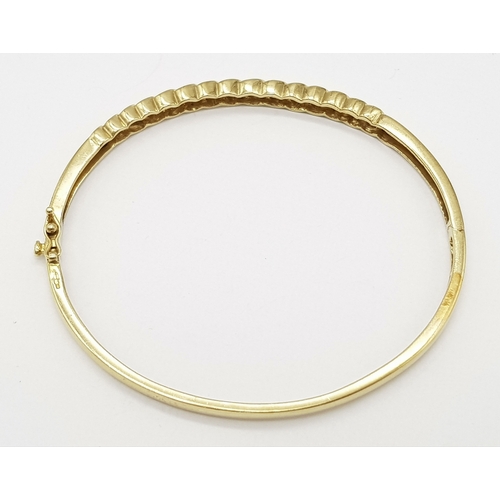 65 - A 9K YELLOW GOLD DIAMOND SET BANGLE 9.1G TOTAL WEIGHT, 0.45CT, 5CM x 6CM. REF: JB 3003