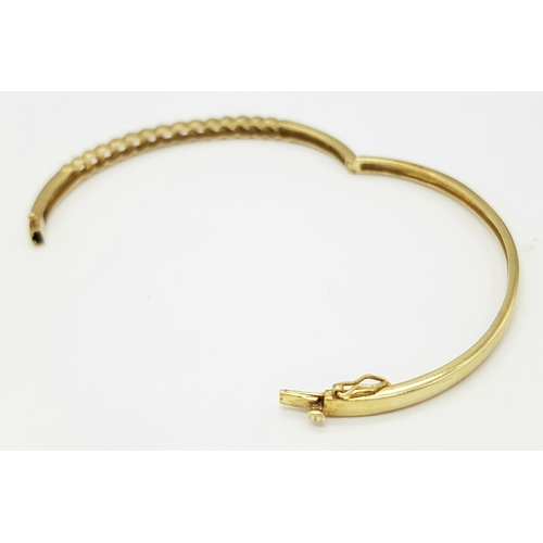 65 - A 9K YELLOW GOLD DIAMOND SET BANGLE 9.1G TOTAL WEIGHT, 0.45CT, 5CM x 6CM. REF: JB 3003
