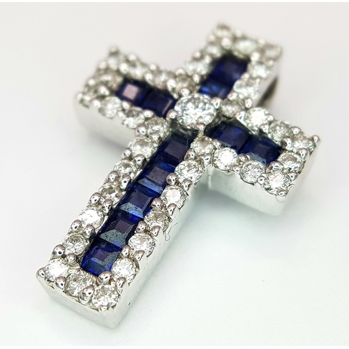 79 - AN 18K WHITE GOLD DIAMOND & SAPPHIRE SET CROSS PENDANT. APPROX 18MM X 13MM. 2.6G TOTAL WEIGHT. REF: ... 