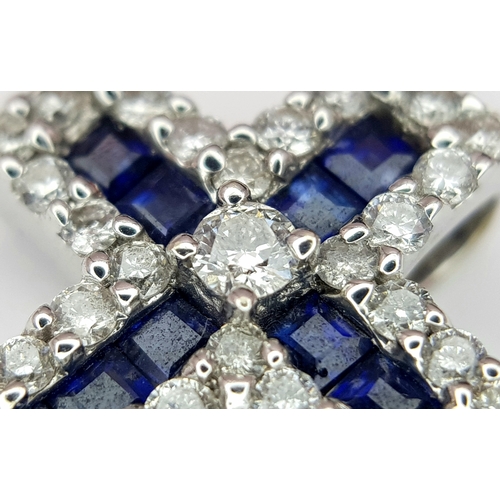 79 - AN 18K WHITE GOLD DIAMOND & SAPPHIRE SET CROSS PENDANT. APPROX 18MM X 13MM. 2.6G TOTAL WEIGHT. REF: ... 