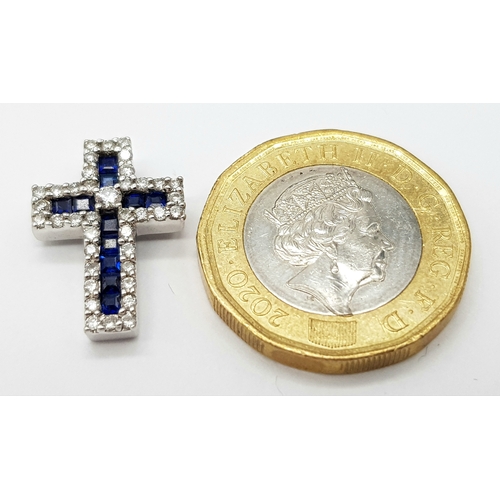 79 - AN 18K WHITE GOLD DIAMOND & SAPPHIRE SET CROSS PENDANT. APPROX 18MM X 13MM. 2.6G TOTAL WEIGHT. REF: ... 