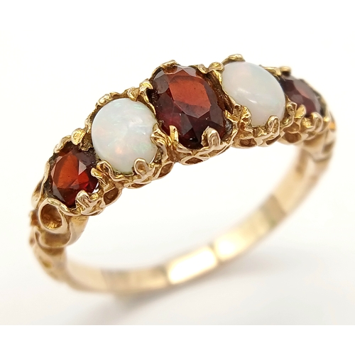 84 - Beautiful vintage 9 CARAT GOLD, OPAL and GARNET RING. Having 2 x FIRE OPALS set to top with 3 x Roun... 