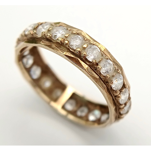 91 - Classic Traditional 9 CARAT GOLD ETERNITY RING. Set with a full circle of sparkling ZIRCONIA GEMSTON... 