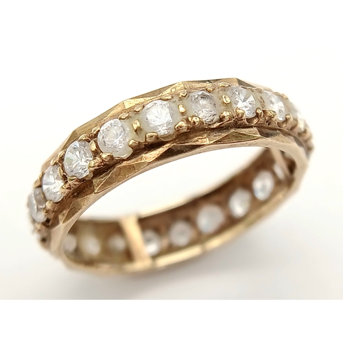 91 - Classic Traditional 9 CARAT GOLD ETERNITY RING. Set with a full circle of sparkling ZIRCONIA GEMSTON... 