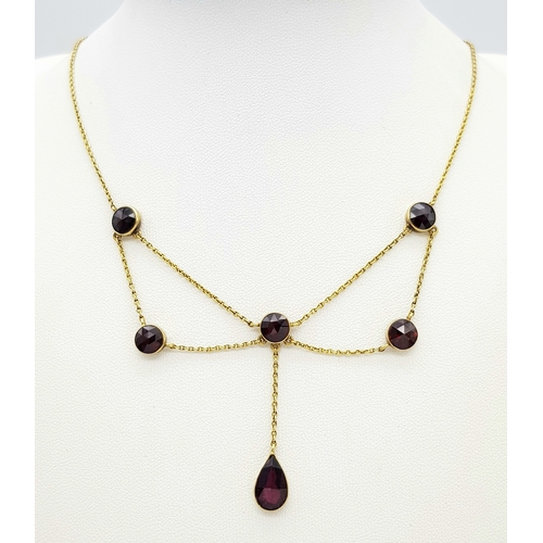 113 - An Edwardian 21K Gold and Garnet Lavaliere necklace. 42cm length. 6.2g total weight.