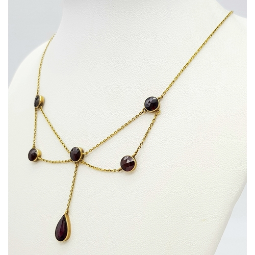 113 - An Edwardian 21K Gold and Garnet Lavaliere necklace. 42cm length. 6.2g total weight.