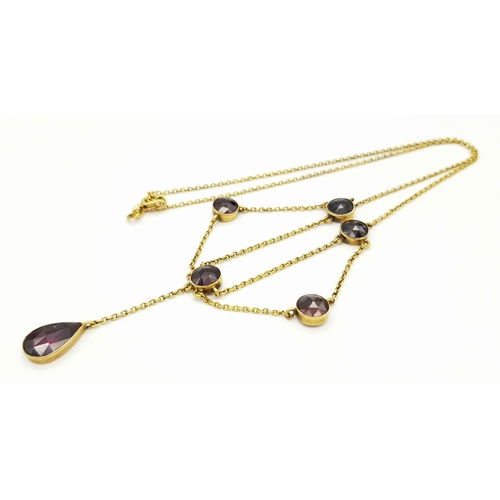 113 - An Edwardian 21K Gold and Garnet Lavaliere necklace. 42cm length. 6.2g total weight.