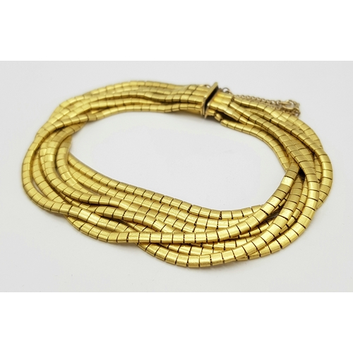 66 - A Beautiful 18K Yellow Gold (tested) Seven Strand Link Bracelet. Clip open design with safety chain.... 